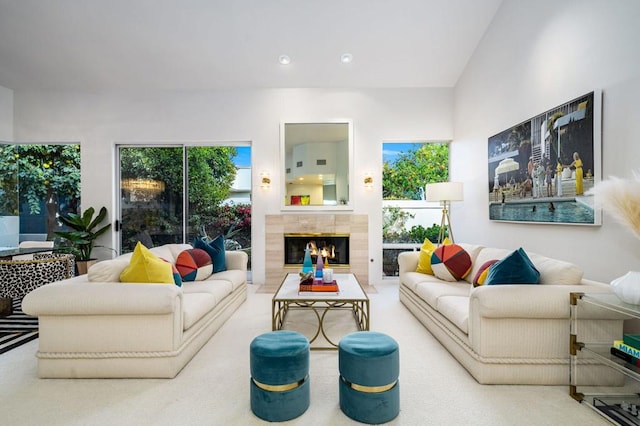 carpeted living room with plenty of natural light and a fireplace