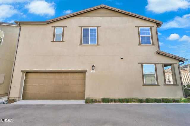 view of side of home featuring a garage