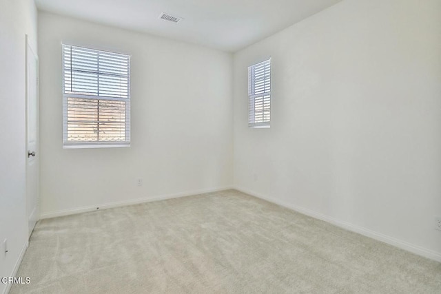 unfurnished room featuring light colored carpet