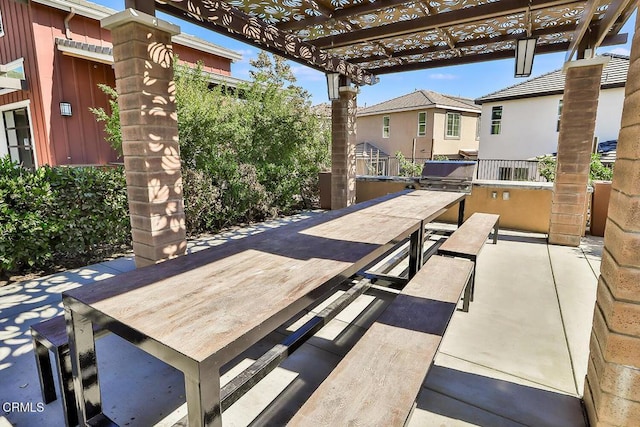 view of patio with a grill, a pergola, and an outdoor kitchen