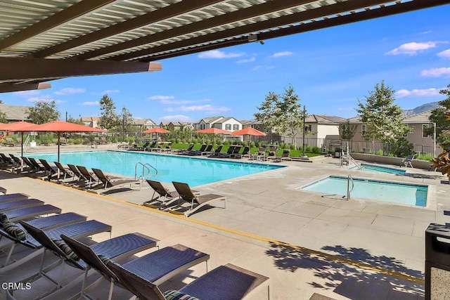 view of pool featuring a pergola, a community hot tub, and a patio area