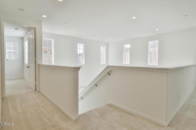 hallway with light colored carpet