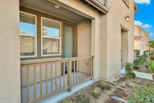 view of exterior entry featuring covered porch