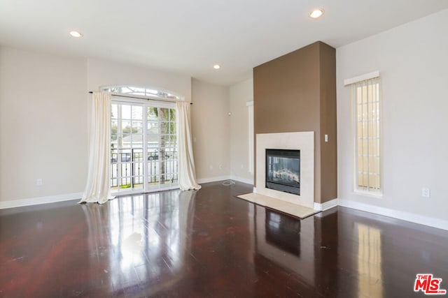 unfurnished living room featuring dark wood-type flooring