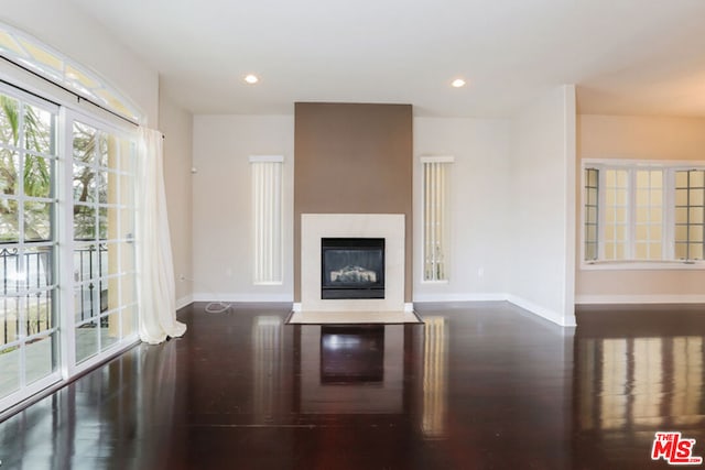 unfurnished living room with dark wood-type flooring