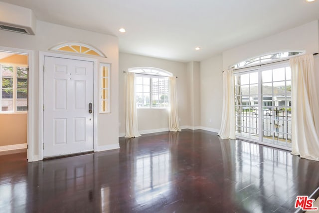 foyer entrance featuring dark hardwood / wood-style floors