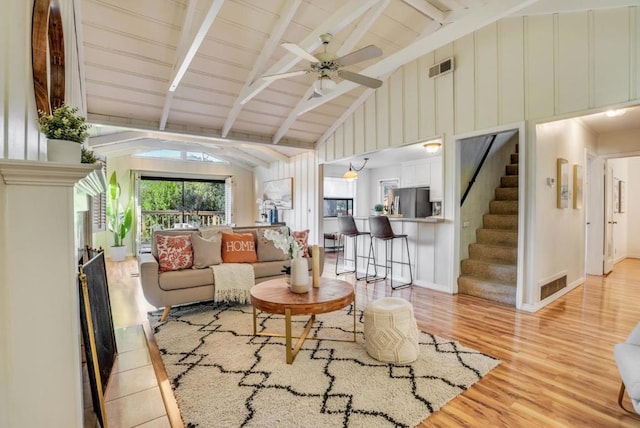 living room featuring beamed ceiling, high vaulted ceiling, ceiling fan, and light hardwood / wood-style floors