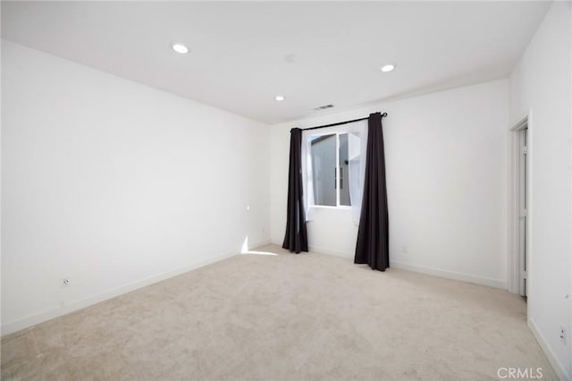 empty room featuring light colored carpet