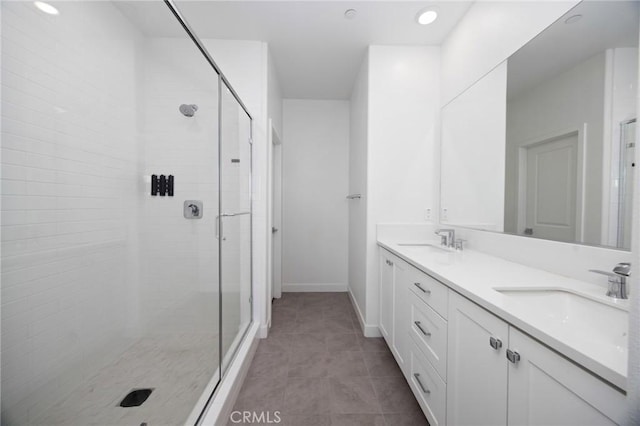 bathroom featuring vanity, tile patterned flooring, and a shower with door