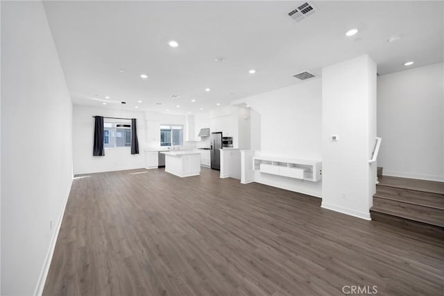 unfurnished living room with dark wood-type flooring