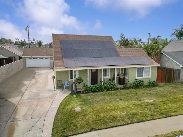 view of front of house featuring a garage, a front yard, and solar panels