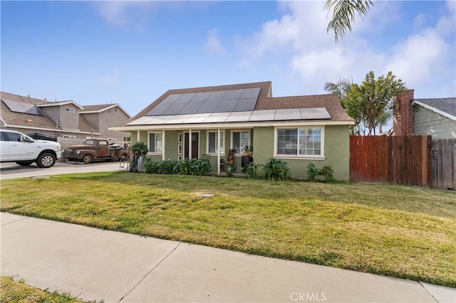 view of front of home featuring a front yard, solar panels, and a porch