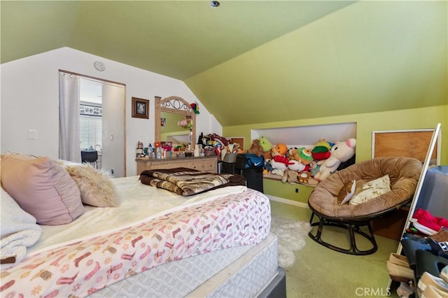 bedroom featuring lofted ceiling and carpet