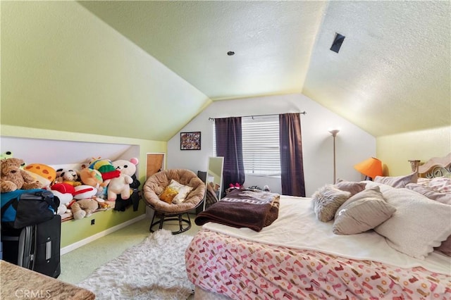 bedroom featuring vaulted ceiling, a textured ceiling, and carpet