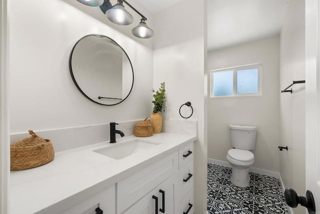 bathroom with tile patterned floors, vanity, and toilet