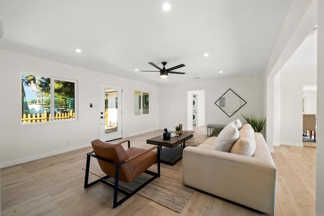 living room with ceiling fan and light hardwood / wood-style floors