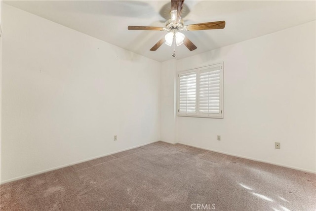 spare room featuring ceiling fan and carpet