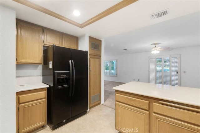 kitchen featuring a tray ceiling, ornamental molding, ceiling fan, black fridge with ice dispenser, and light brown cabinets