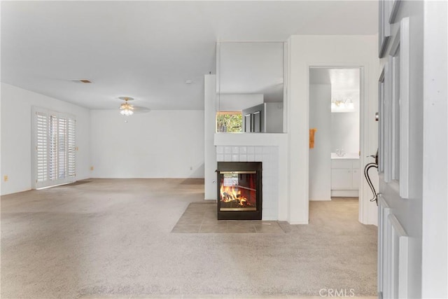 living room with ceiling fan, a fireplace, light carpet, and a wealth of natural light