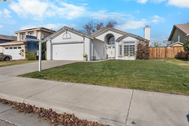 ranch-style house featuring a garage and a front yard