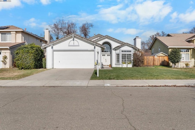 view of front of home with a garage and a front lawn