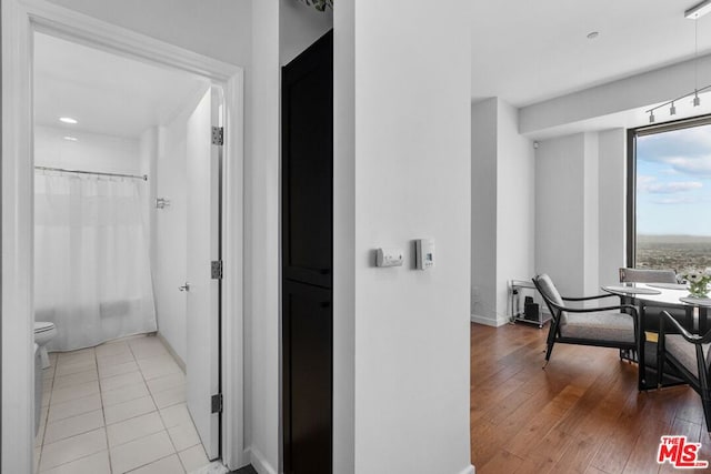 hallway with light hardwood / wood-style floors