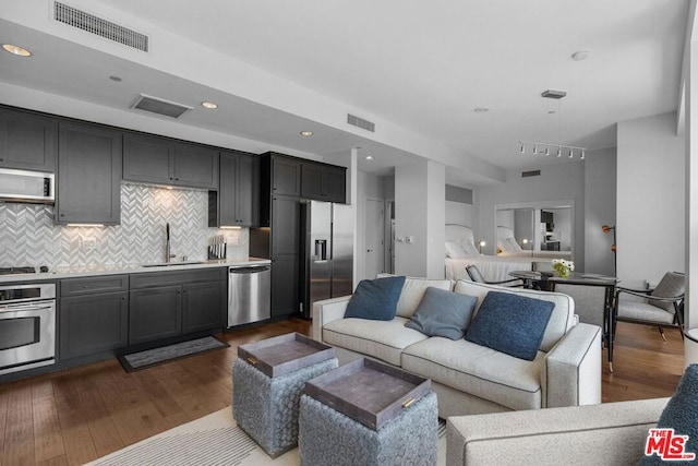 living room with sink and dark hardwood / wood-style floors