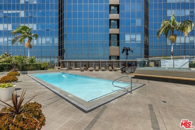 view of swimming pool with a patio area