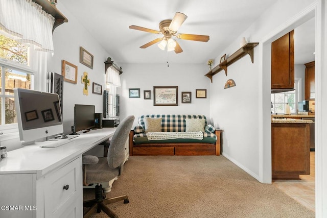 office area with plenty of natural light, light colored carpet, and ceiling fan