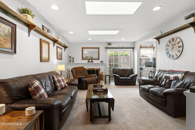 living room with carpet and a skylight