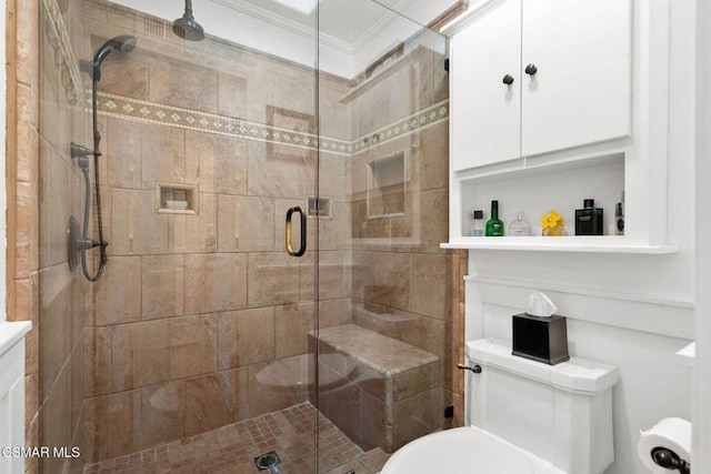 bathroom featuring crown molding, toilet, and a shower with door