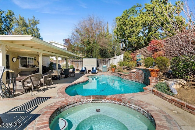 view of pool with an in ground hot tub and a patio area