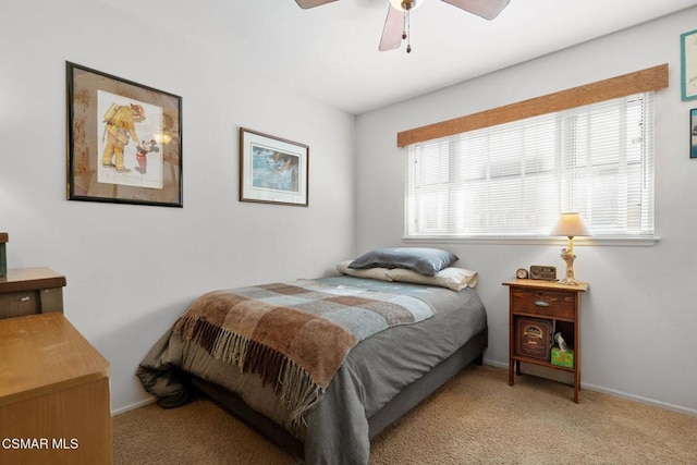 carpeted bedroom with ceiling fan and multiple windows