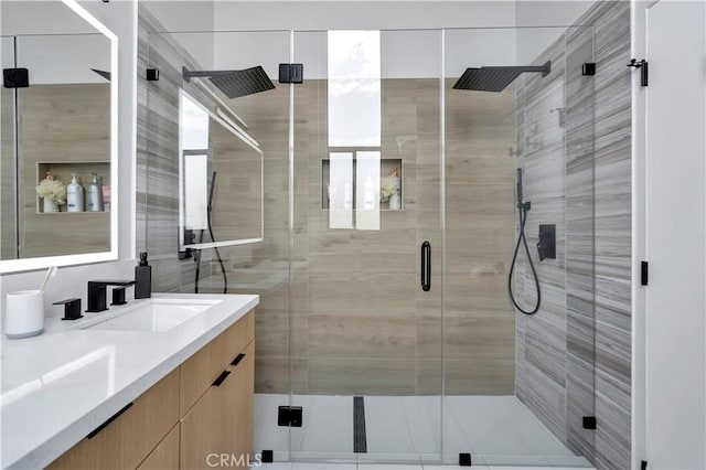 bathroom featuring vanity and a shower with shower door