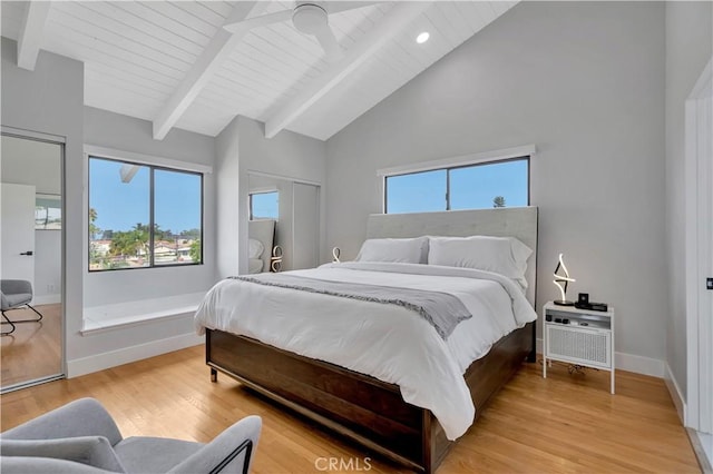 bedroom featuring beamed ceiling, high vaulted ceiling, ceiling fan, and light hardwood / wood-style floors