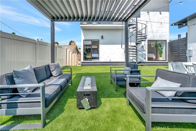 view of yard with an outdoor living space with a fire pit