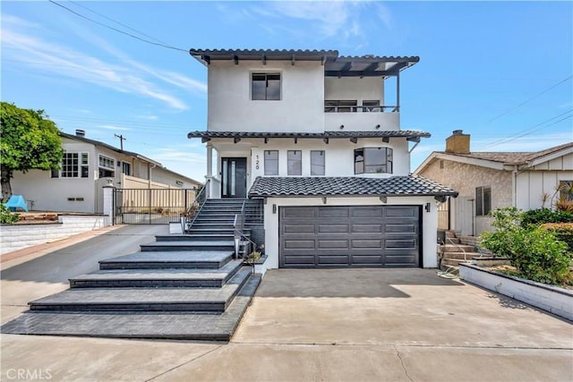 mediterranean / spanish-style house with a garage and a balcony