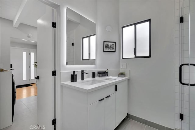 bathroom with vanity, a shower with shower door, and tile patterned flooring