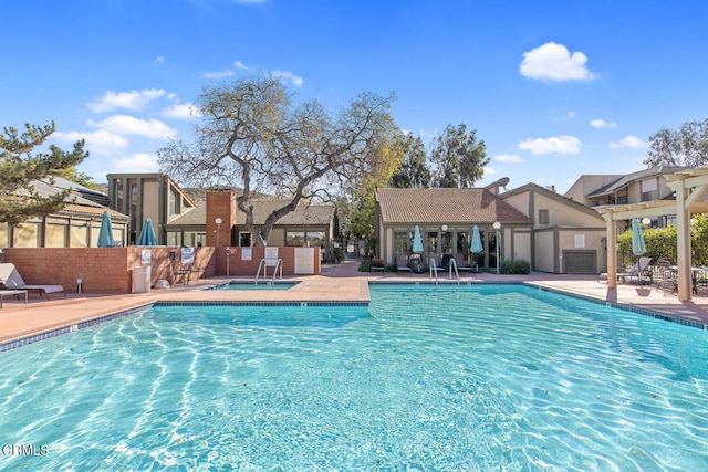 view of swimming pool with a patio and a pergola