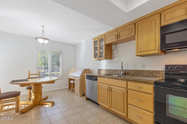 kitchen featuring light tile patterned flooring, sink, decorative light fixtures, dark stone counters, and black appliances