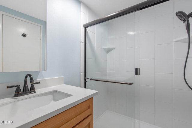 bathroom featuring an enclosed shower and vanity