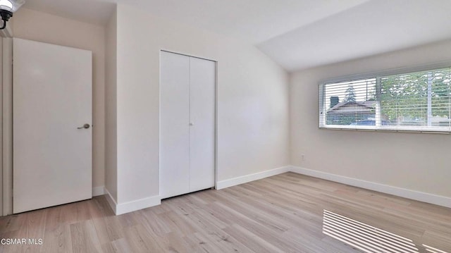 unfurnished bedroom featuring light hardwood / wood-style floors and a closet