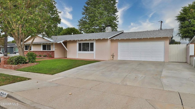 ranch-style home featuring a garage and a front lawn