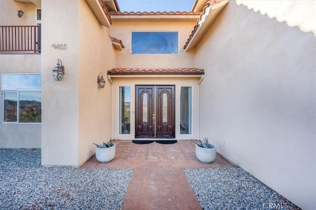 entrance to property with a patio area and french doors