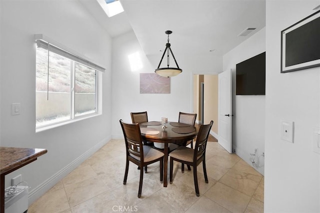 dining area with baseboards, visible vents, a skylight, and light tile patterned floors