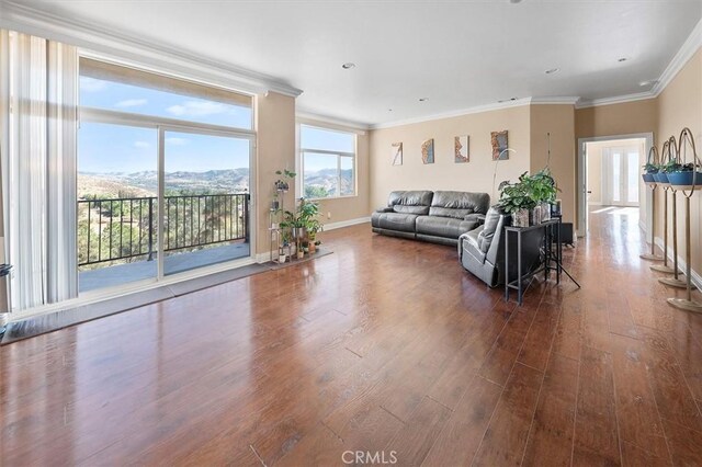 living area with crown molding, dark wood-style floors, and baseboards