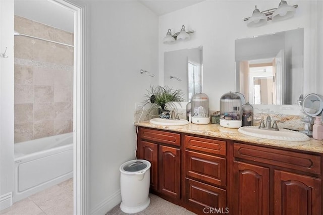 bathroom featuring tiled shower / bath, vanity, and tile patterned floors