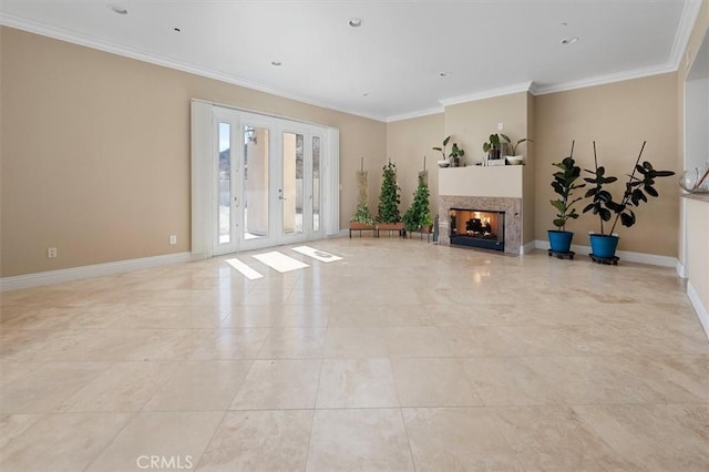 unfurnished living room featuring a multi sided fireplace, ornamental molding, and french doors