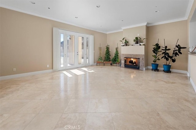 unfurnished living room featuring baseboards, a multi sided fireplace, ornamental molding, and french doors