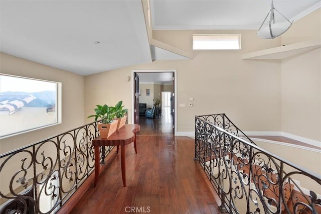 hallway with an upstairs landing, dark wood-type flooring, crown molding, and baseboards